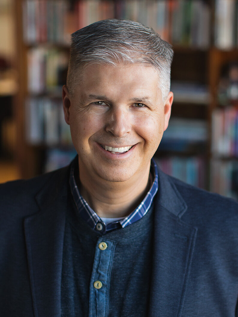 Chuck Marohn headshot of a male with white skin, a blue shirt and blazer, short gray hair and a smile